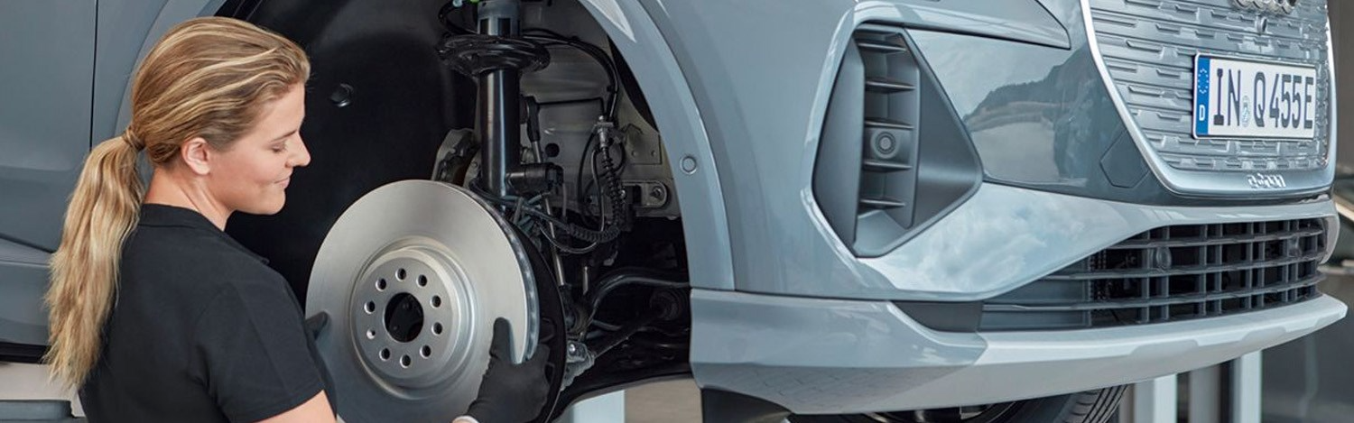 Audi Mechanic Working On Alloys