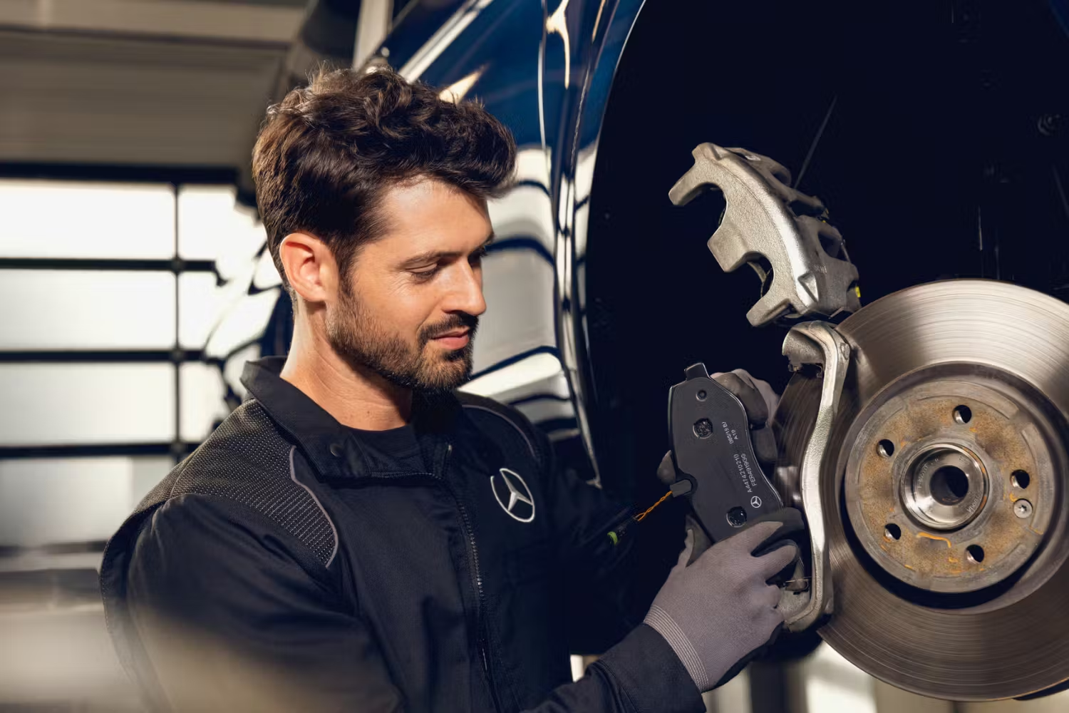 Mercedes Mechanic Inspecting Mercedes-Benz Brake Disc