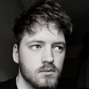Black and white portrait of a person looking thoughtfully to one side.