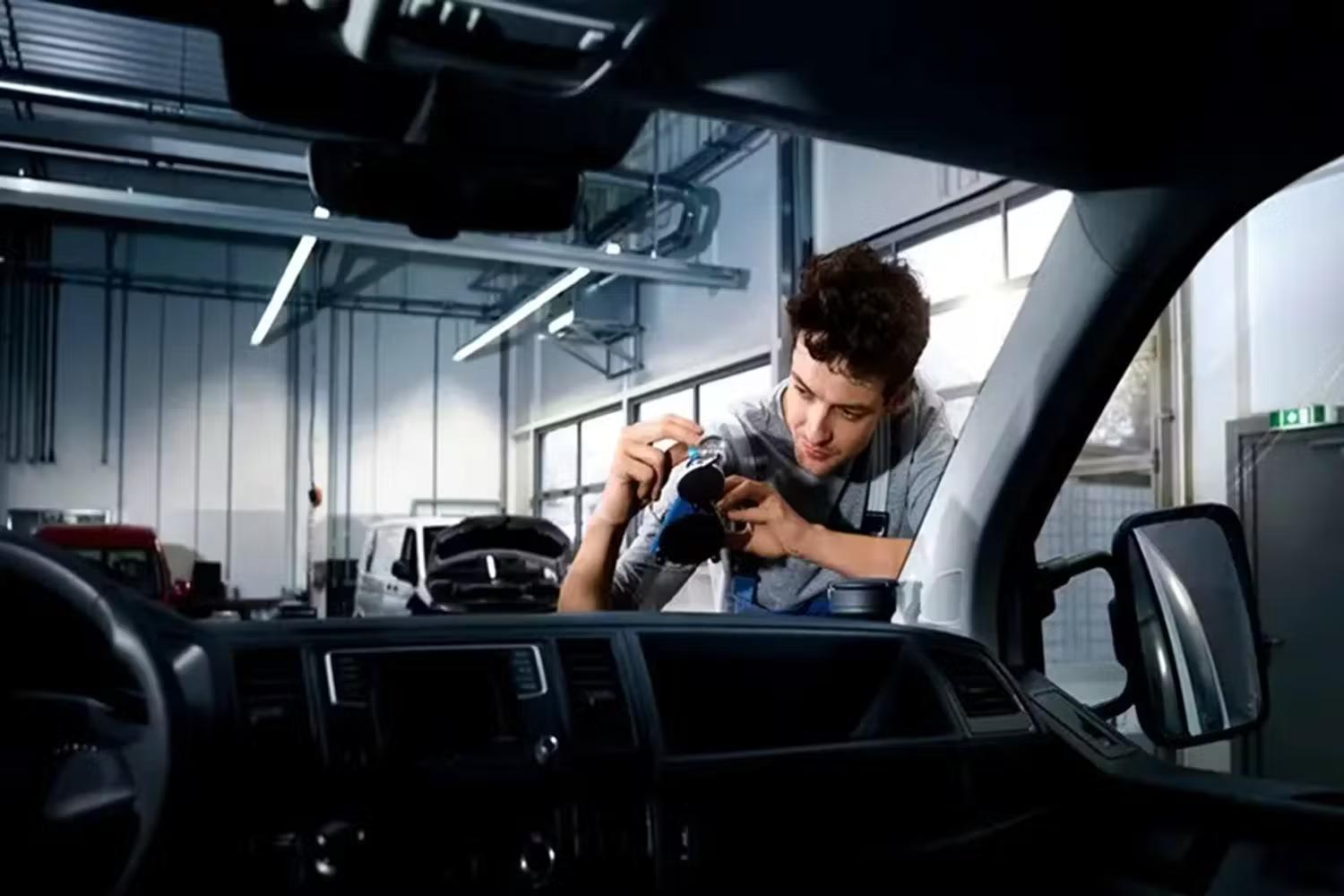 Volkswagen Mechanic inspecting wind screen