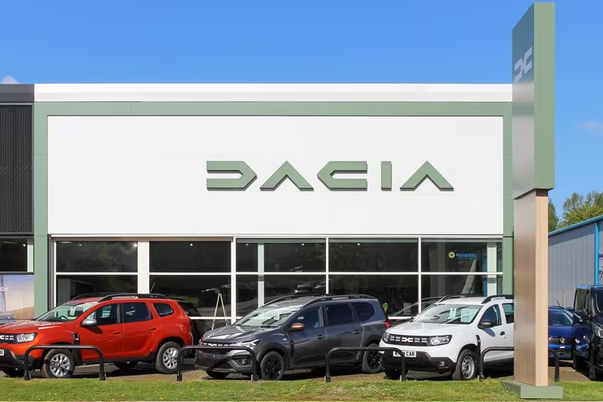 Exterior view of Dacia dealership with a range of Dacia models parked outside the showroom.