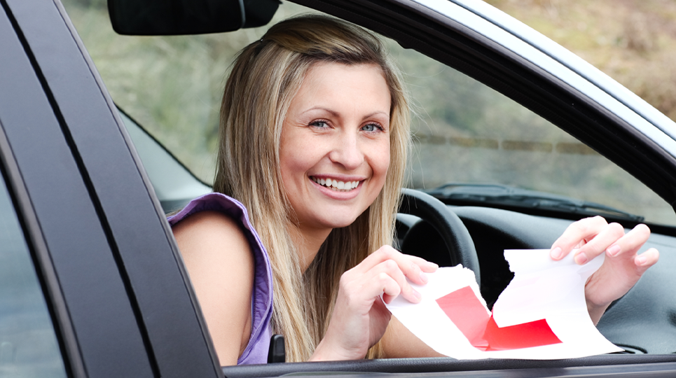 woman tearing the learner's permit
