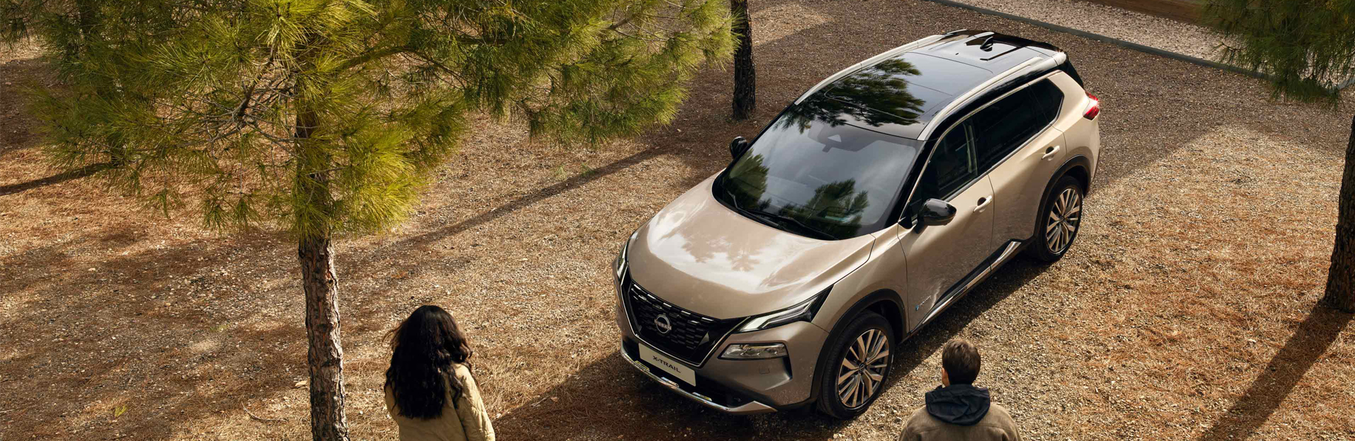 People walking up to a nissan xtrail parked outside.
