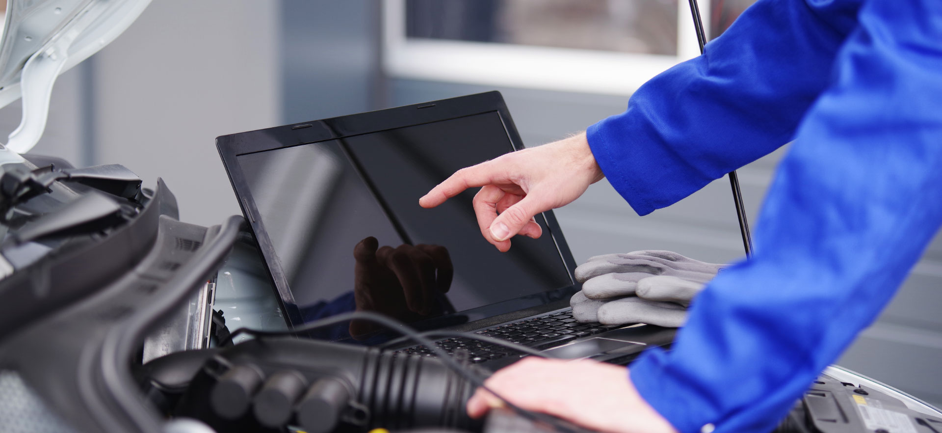 Mechanic using diagnostic equipment