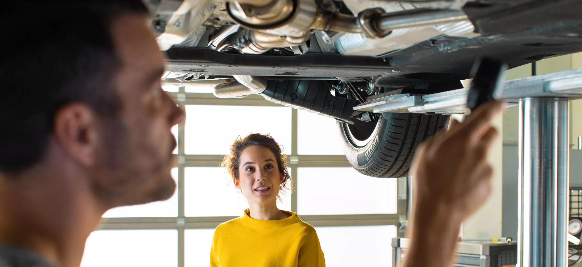 Mechanic Inspecting Volkswagen from beneath