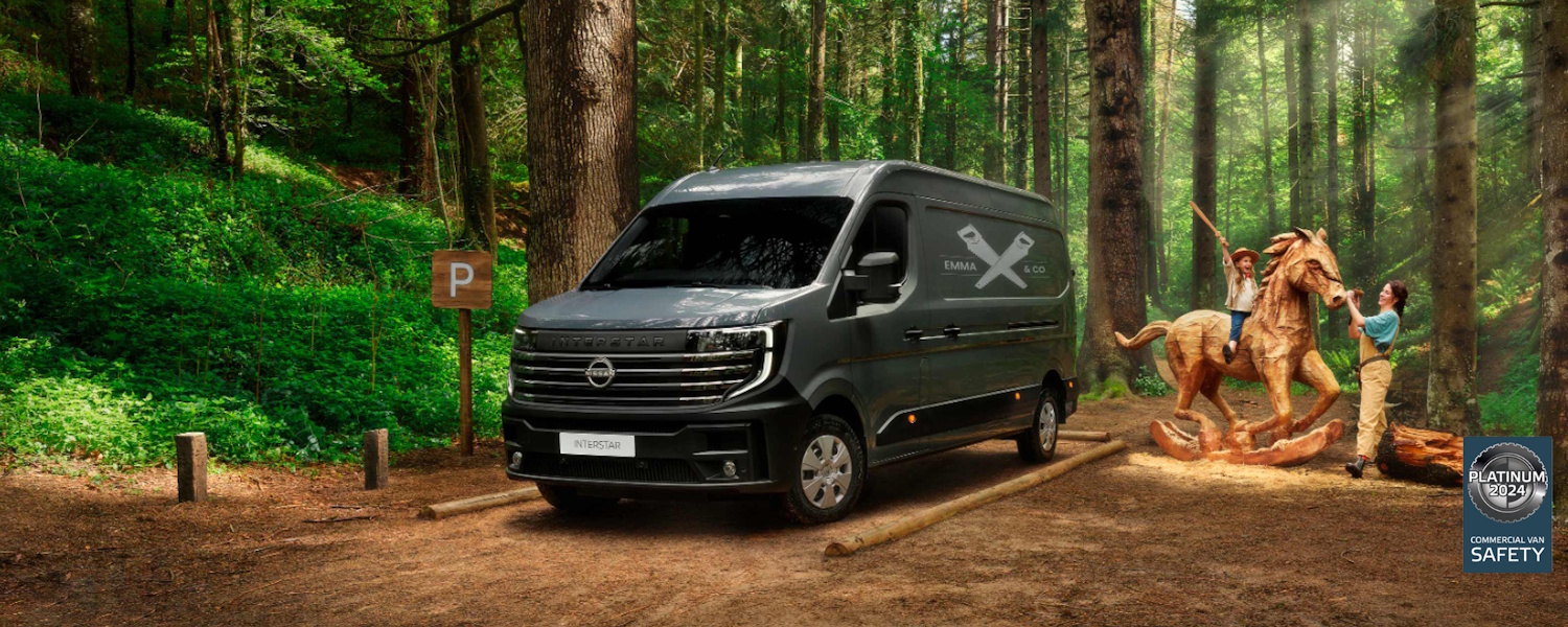 New Nissan Interstar in a forest with a company logo printed on the side