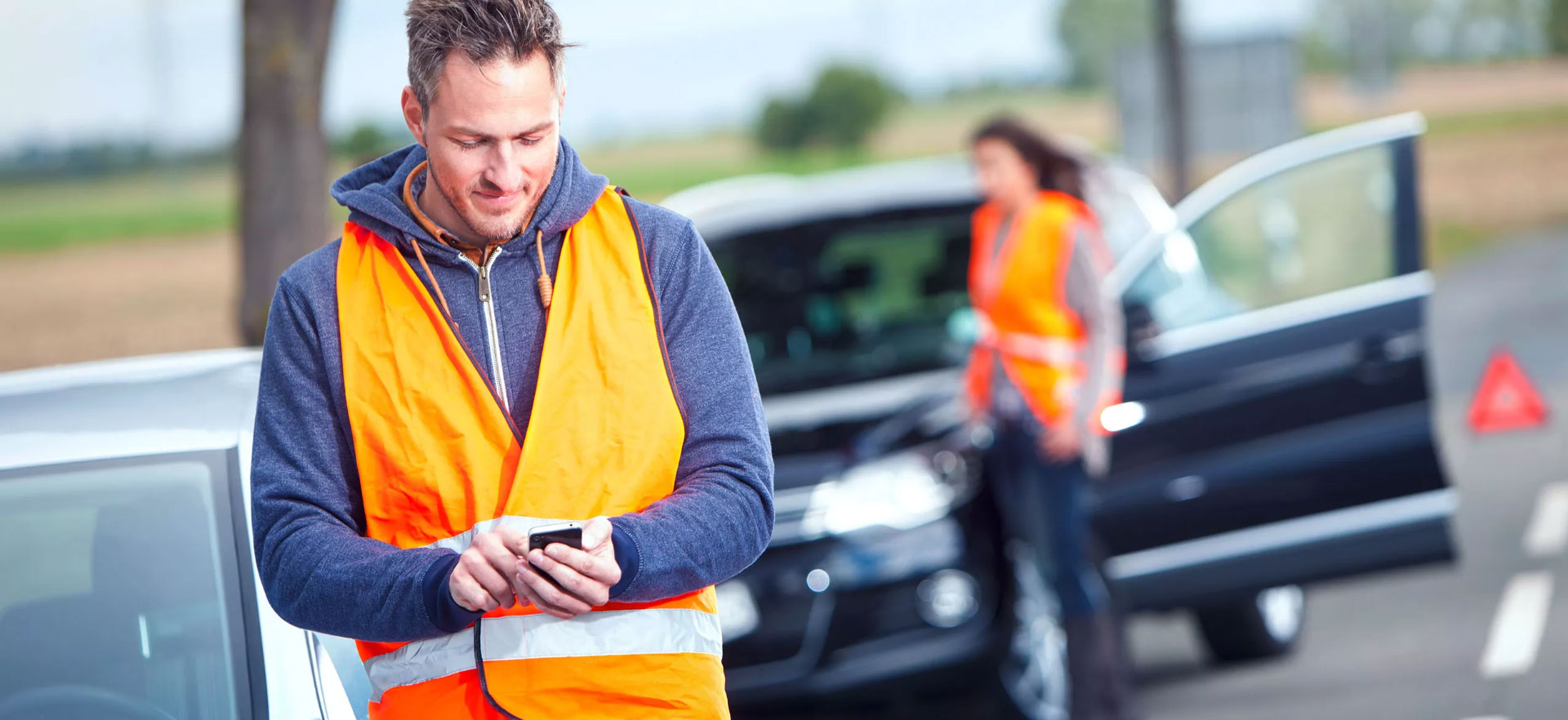 Person wearing high vis on their phone