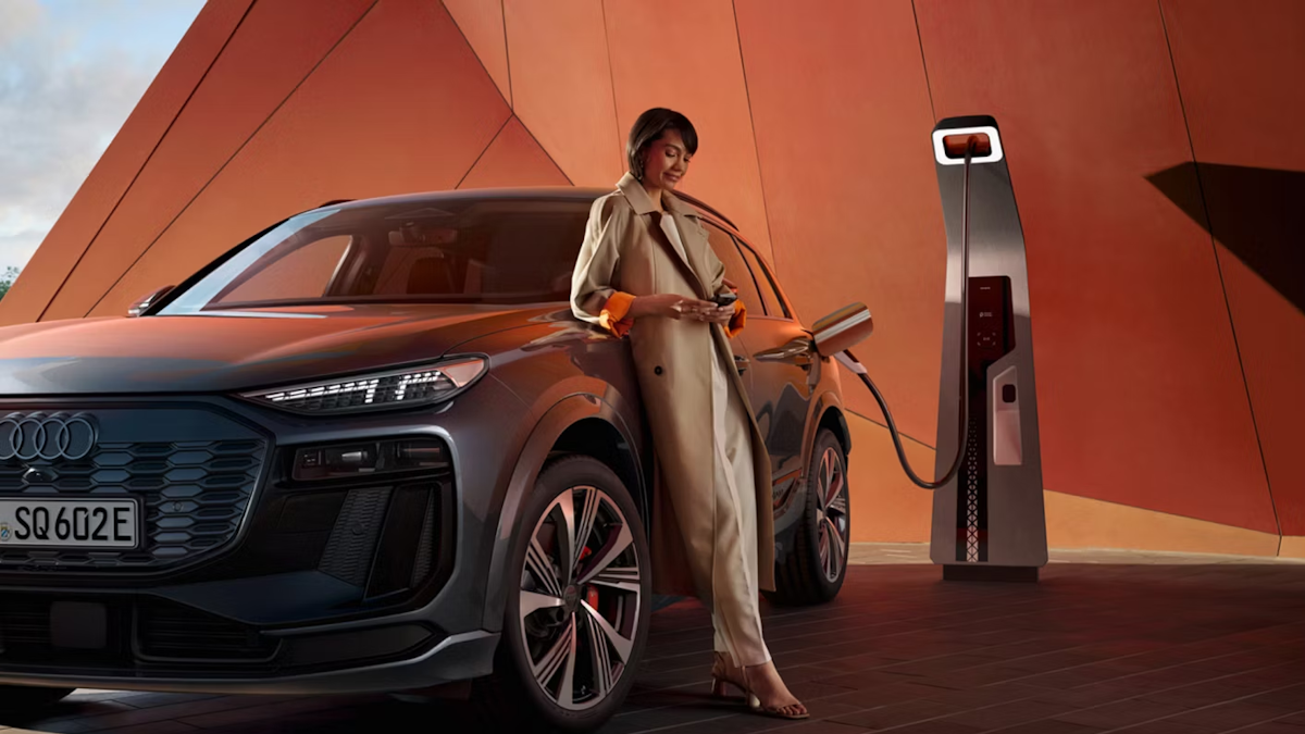 woman charging the Audi Q6 SUV E-tron