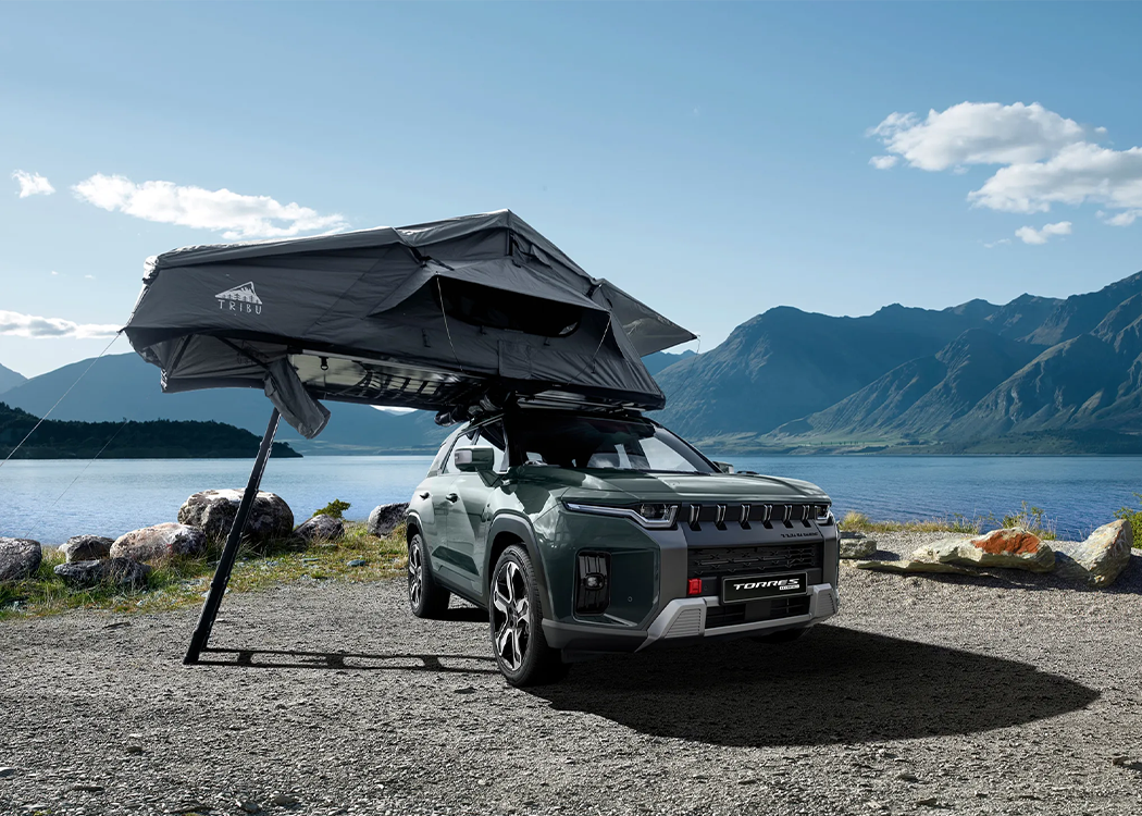 KGM Torres Hybrid with Tent in front of lake