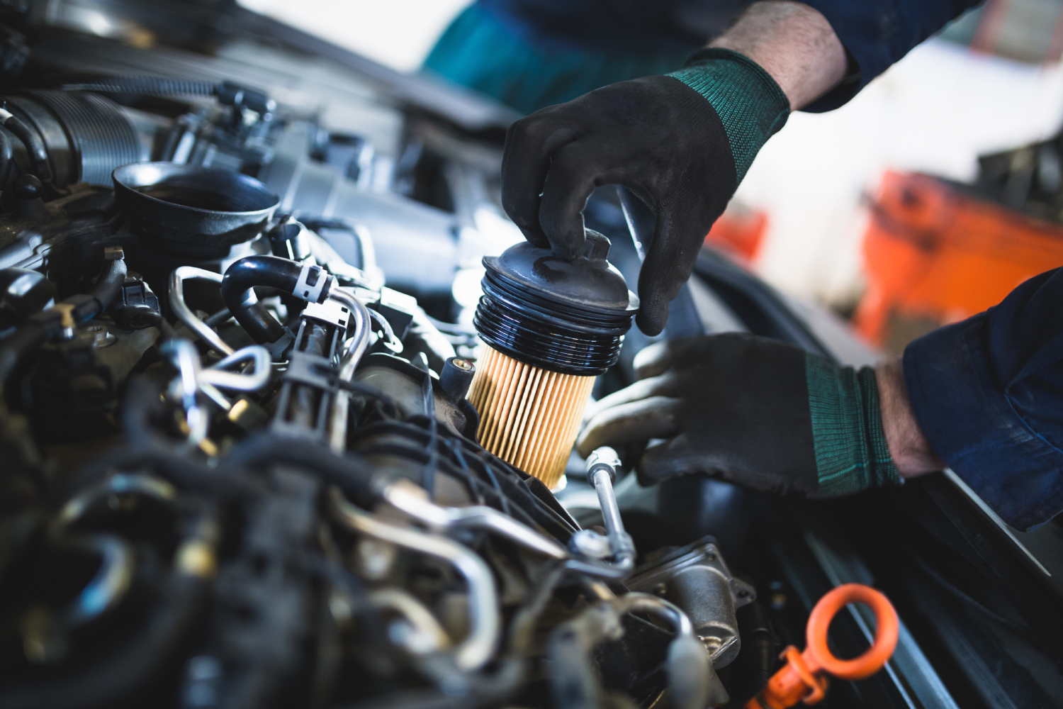 Close-up of a mechanic focusing on engine components during a car repair.