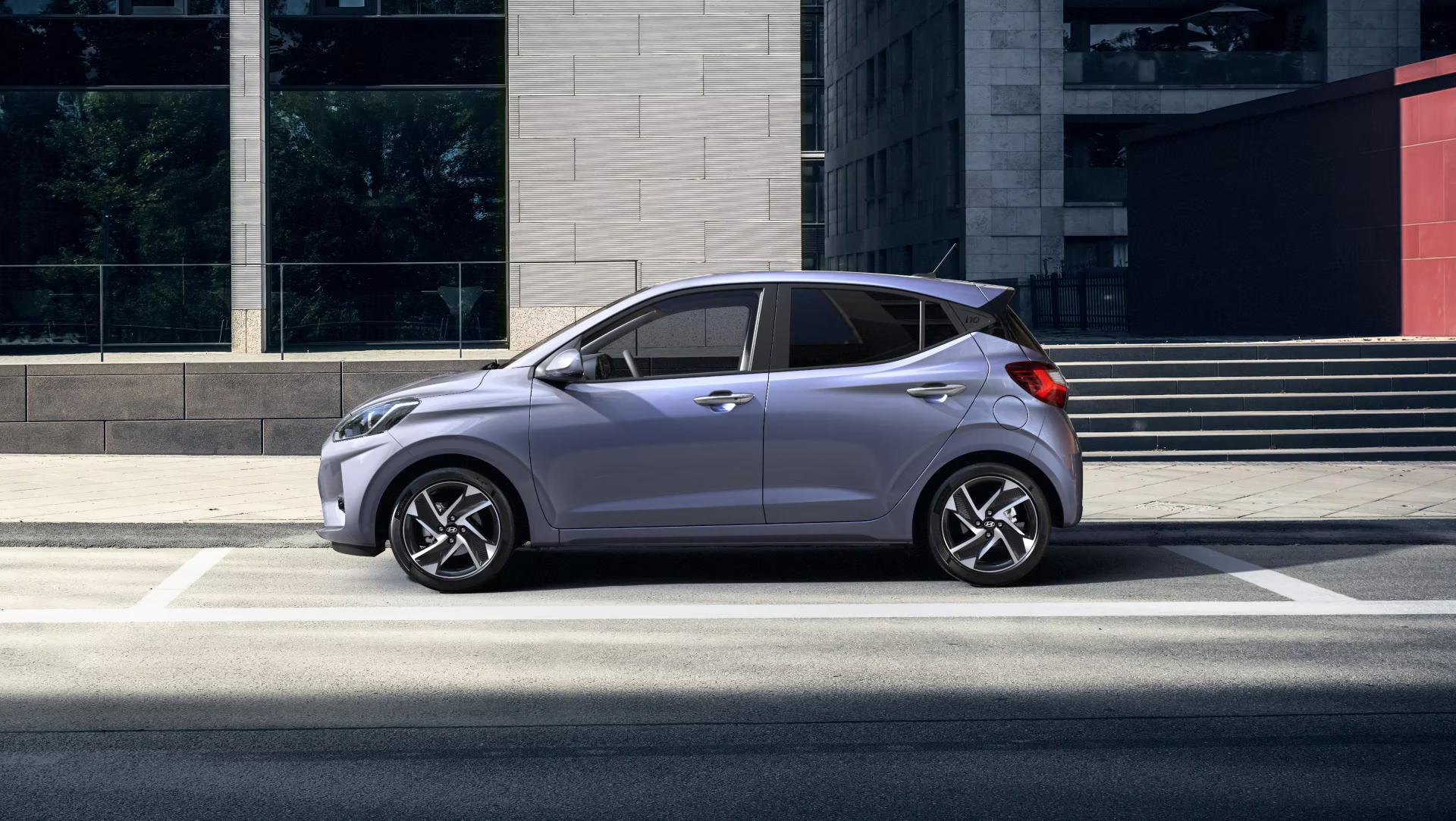 Purple Hyundai i10 driving along the road side view