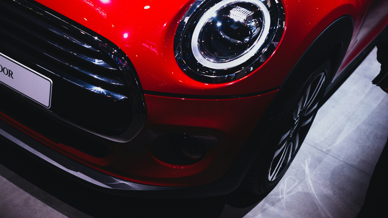 Close-up of red Mini headlight and front grille.