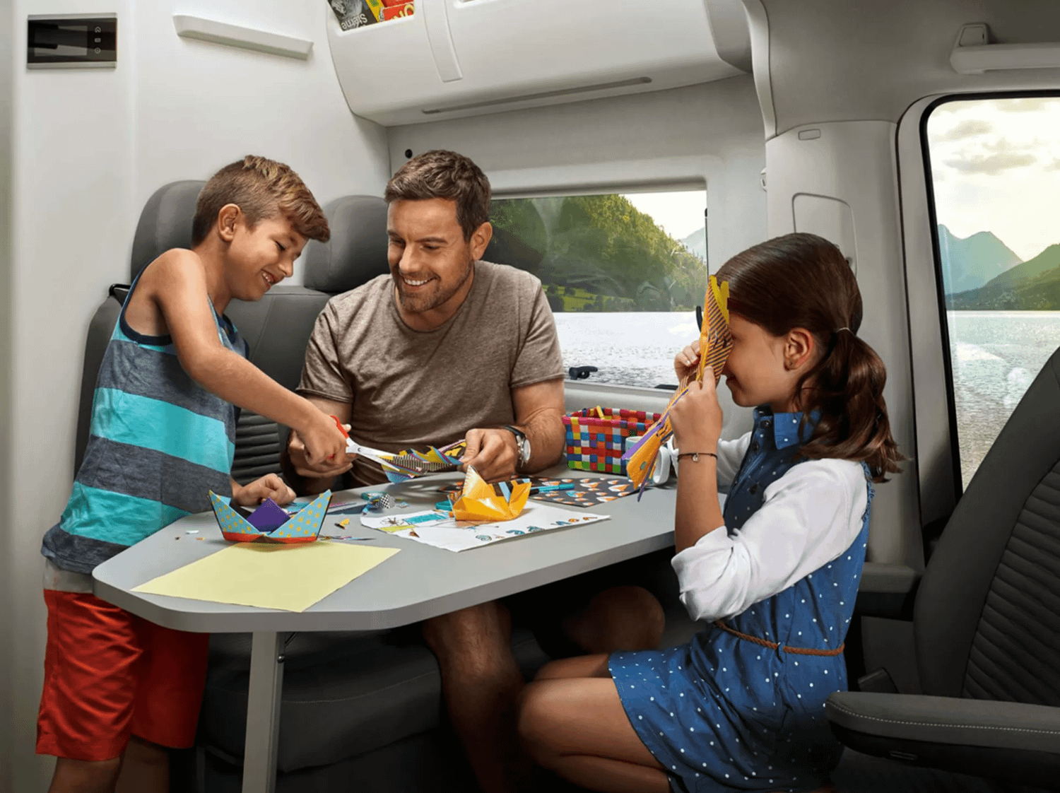 Family sat at table in New Volkswagen Grand California