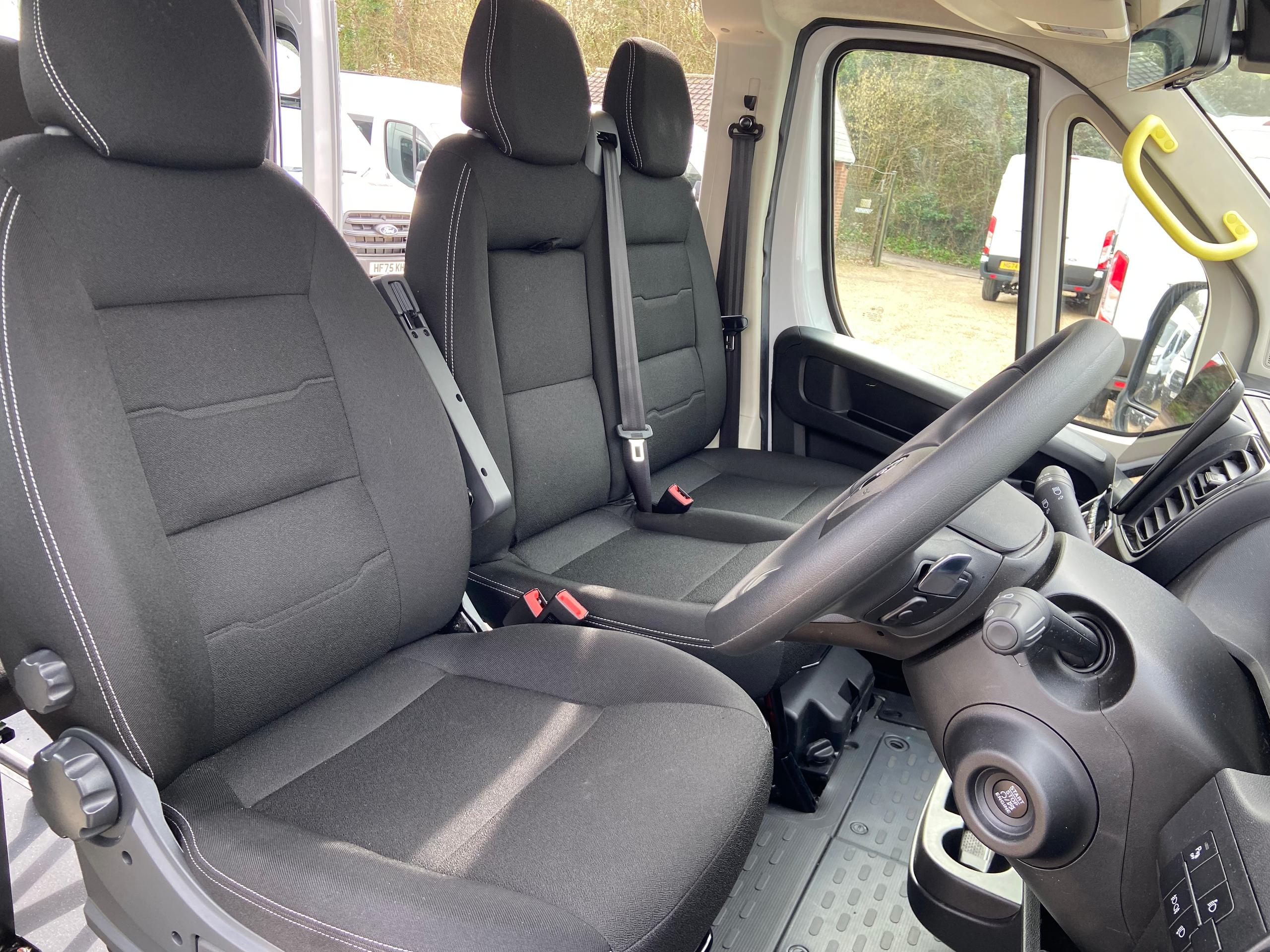 Front passenger seats of CVMinibus with seatbelts and interior trim visible.