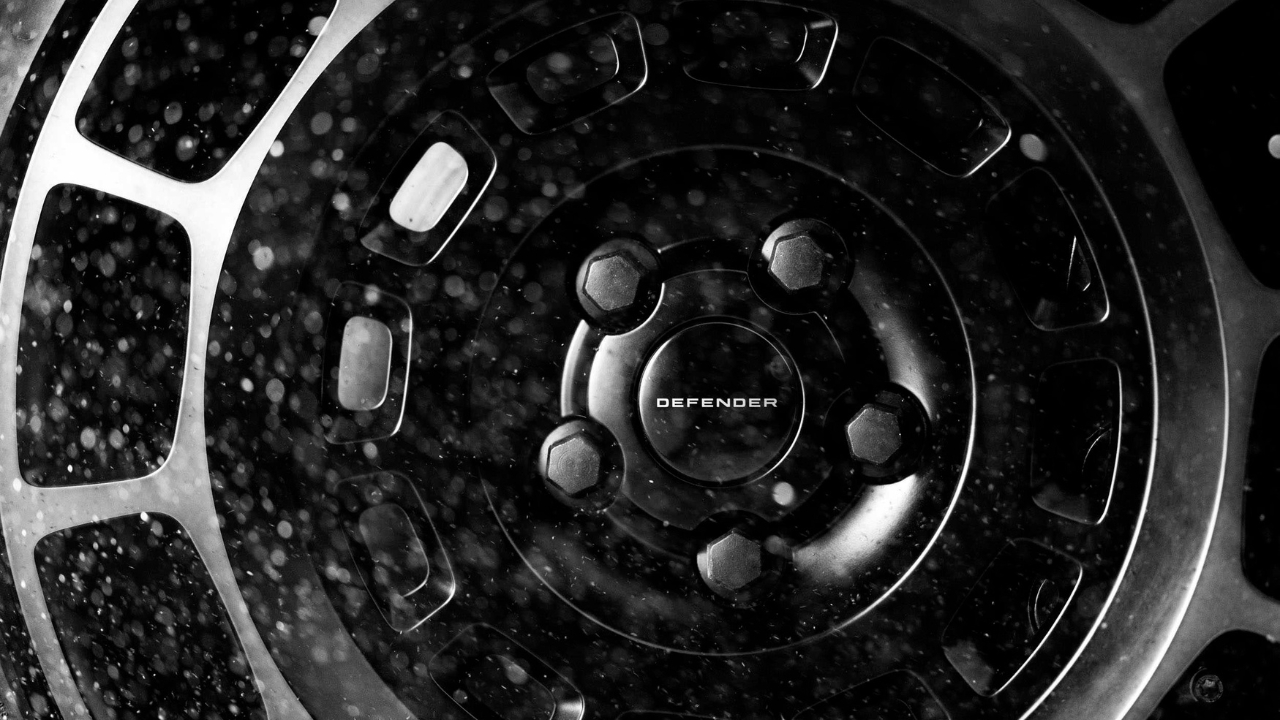 Close-up detail of the Defender OCTA Black wheel hub and off-road tire.
