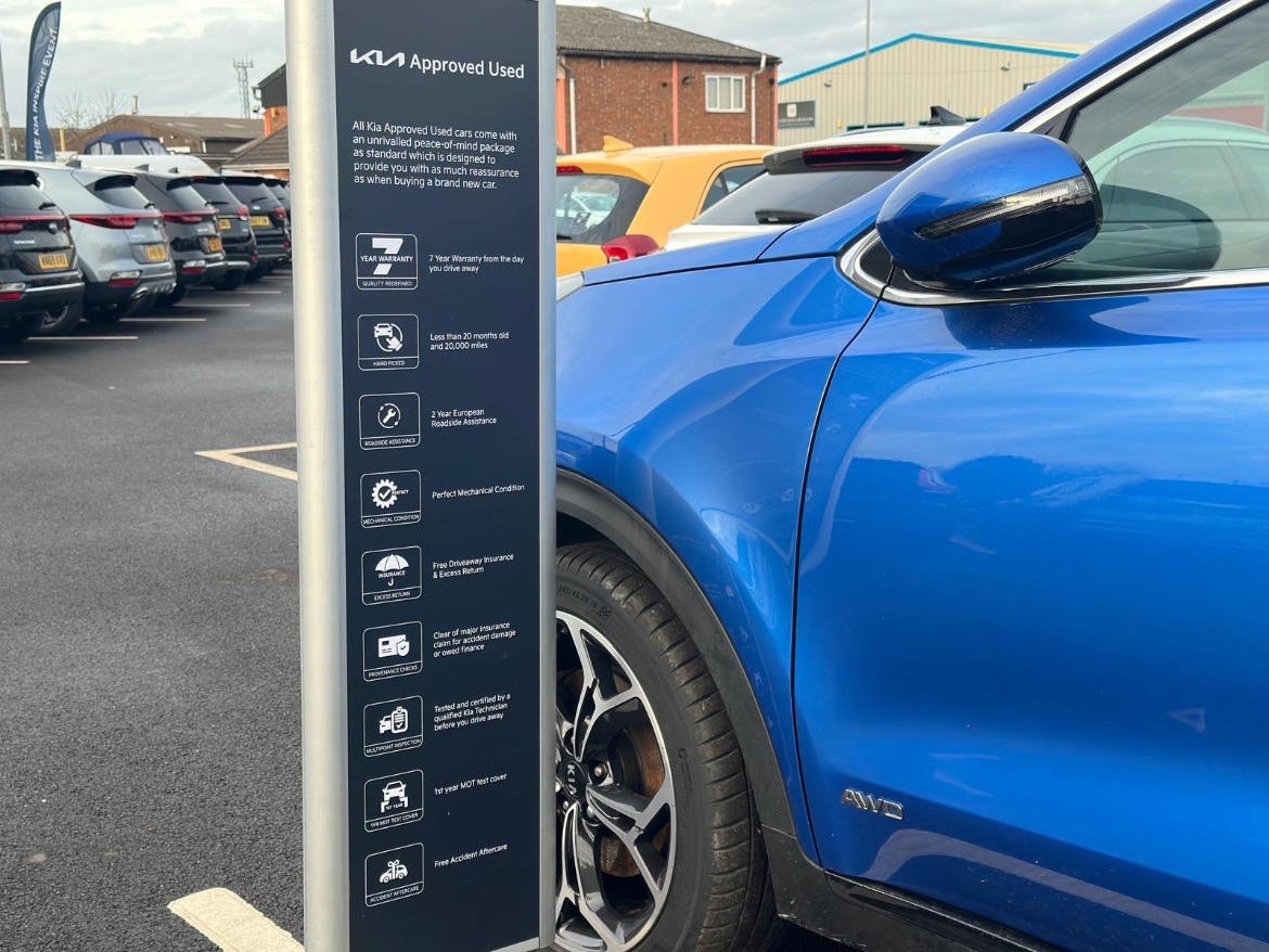 Kia Approved Used programme display highlighting warranty, inspection and aftercare benefits available to customers.