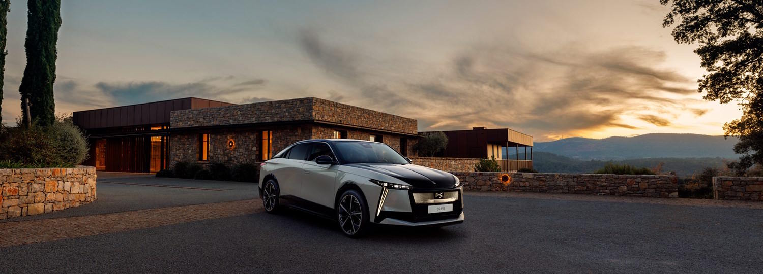 DS no8 in white, with a house behind and a sunset in the background