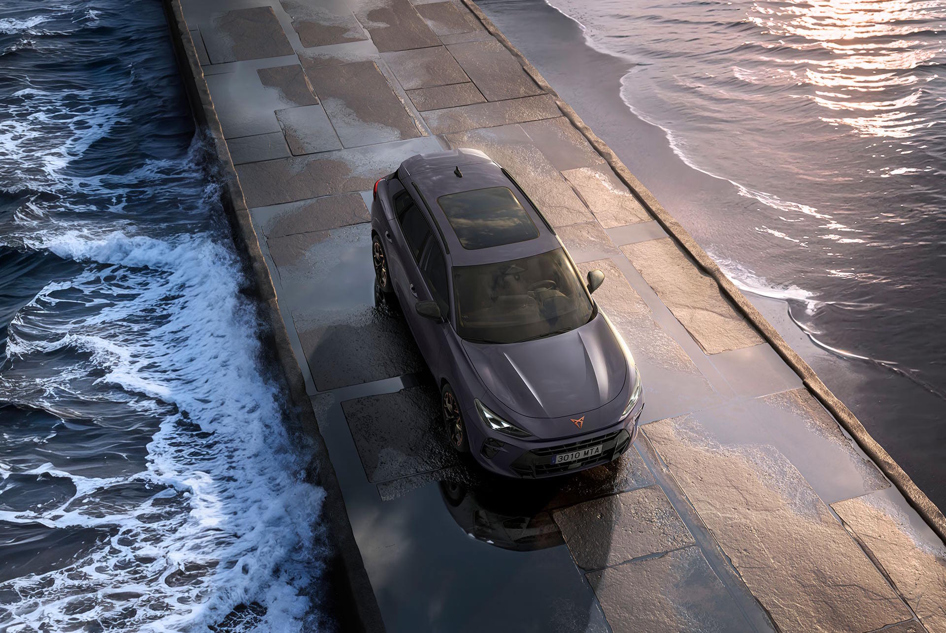 CUPRA Terramar parked on a coastal walkway beside the sea.