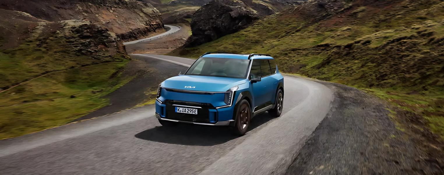 Kia EV9 Driving Outdoors in a winding mountain road.