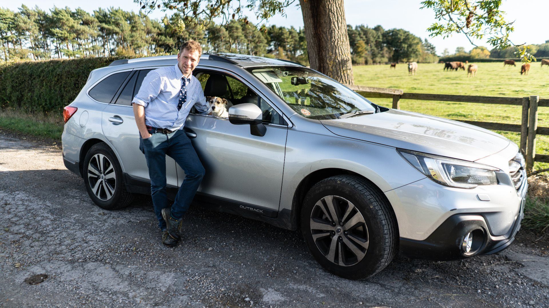 Man leaning on a Subaru