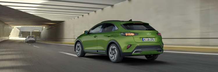 Kia Stonic Rear View Driving In a modern underpass