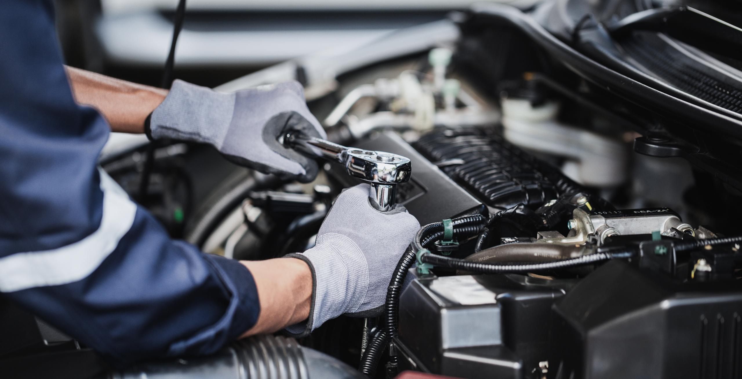 person servicing a car