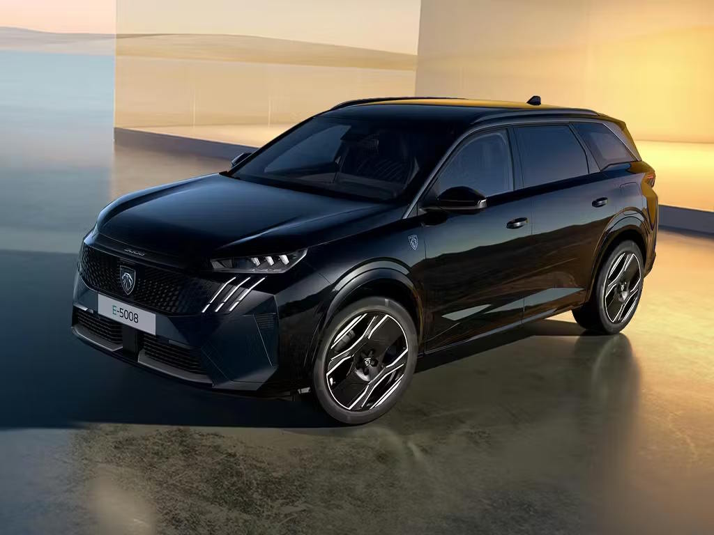 Front three-quarter view of the Peugeot E-5008 electric SUV in black, featuring the bold new-generation grille, striking LED fang daytime running lights and sculpted diamond-cut alloy wheels.