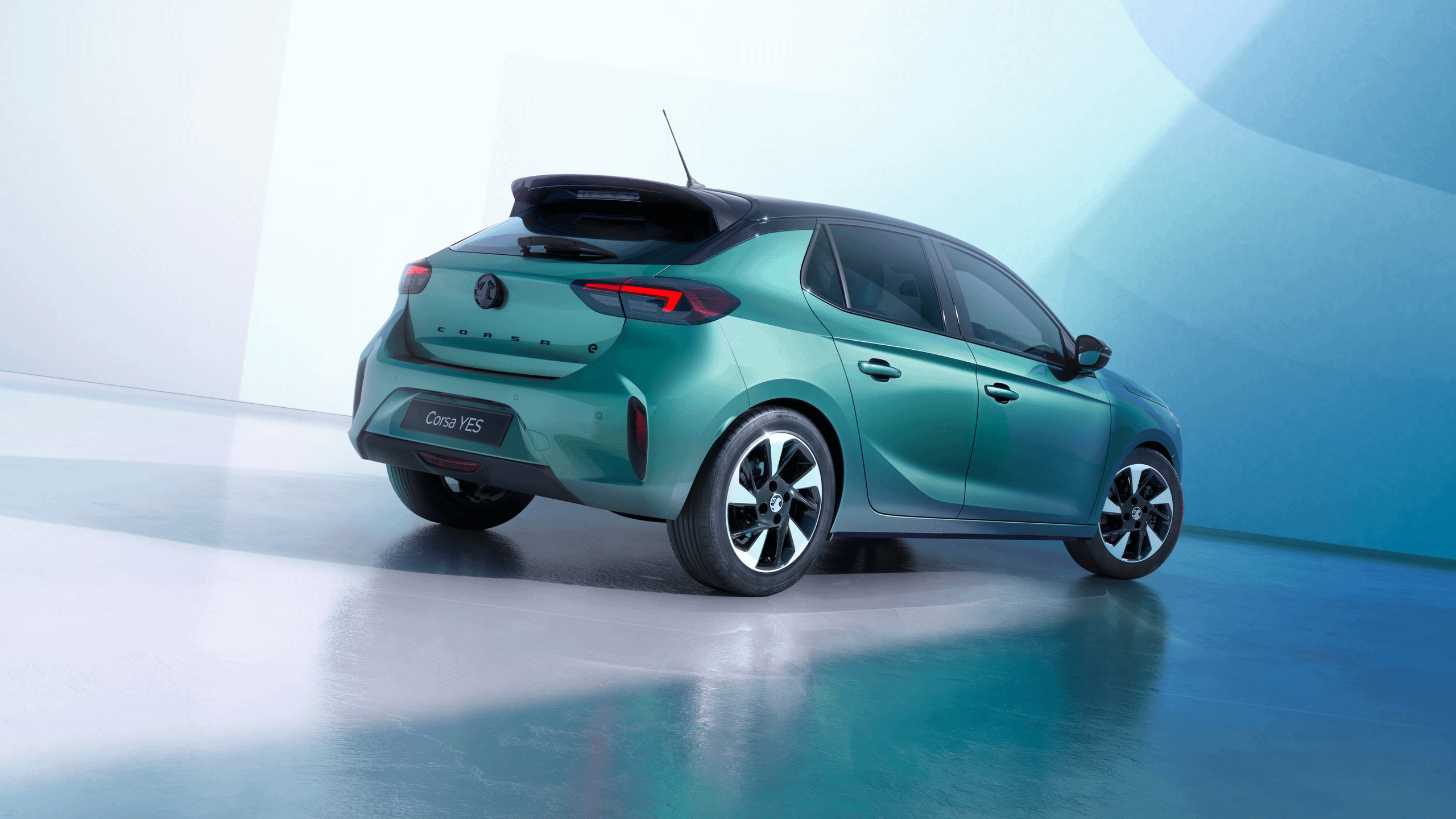 Vauxhall Corsa YES in green shown from the rear three-quarter angle in a studio environment.