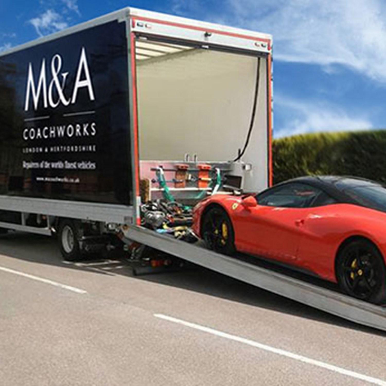Sports car being loaded onto lorry