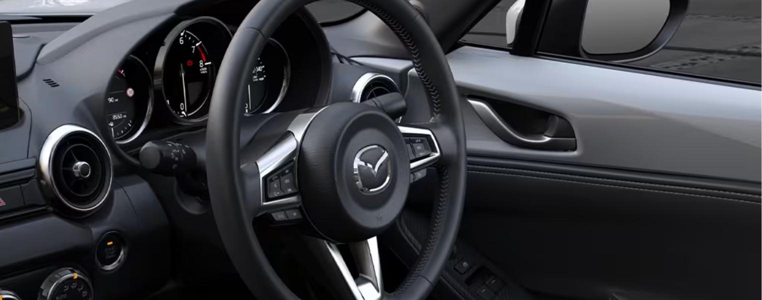 Close-up of Mazda MX 5 Steering Wheel And Cluster.