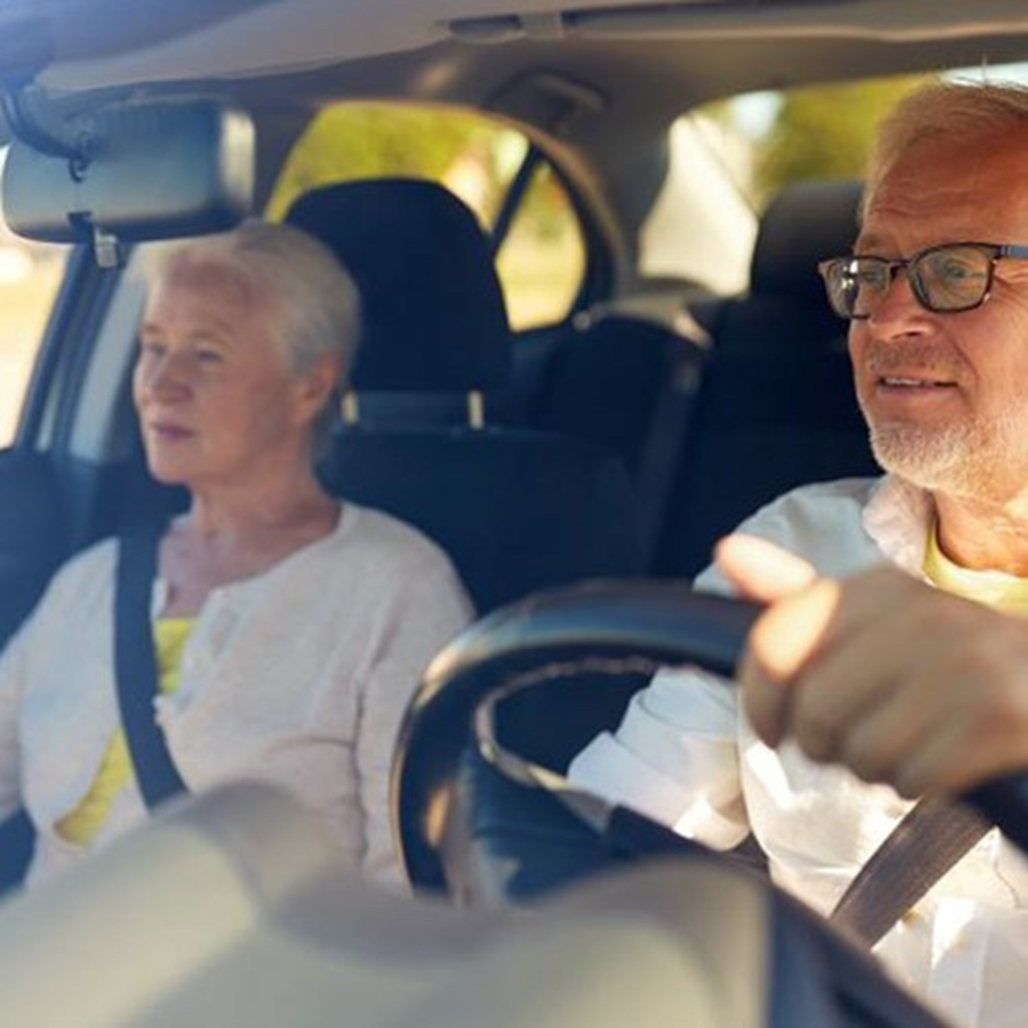 man driving with woman in the passenger seat
