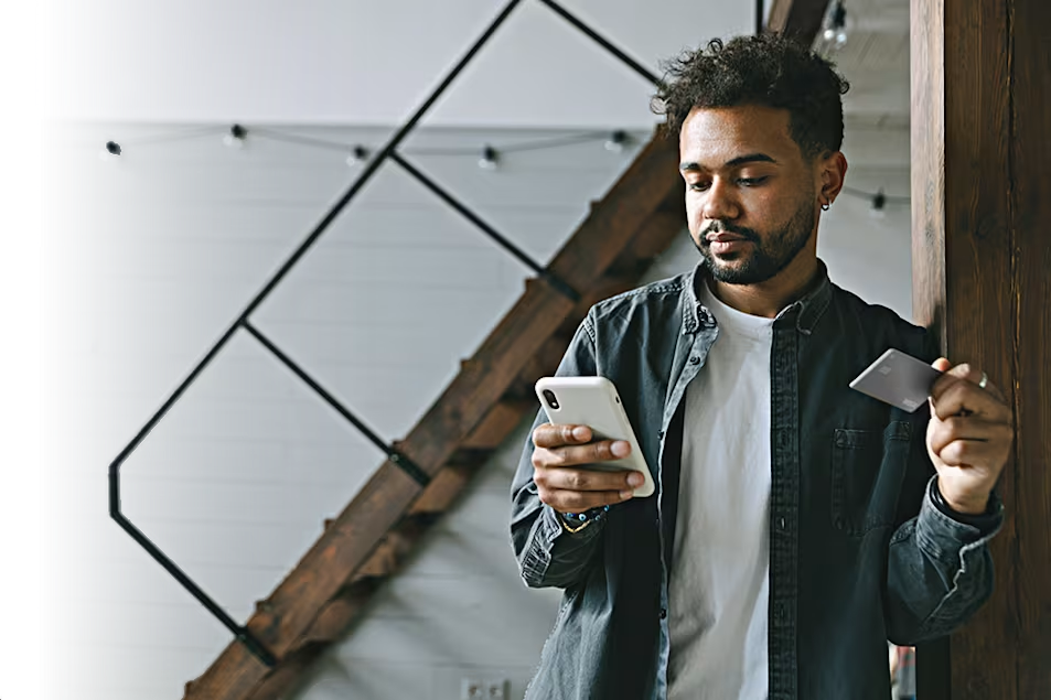 man on phone with bank card