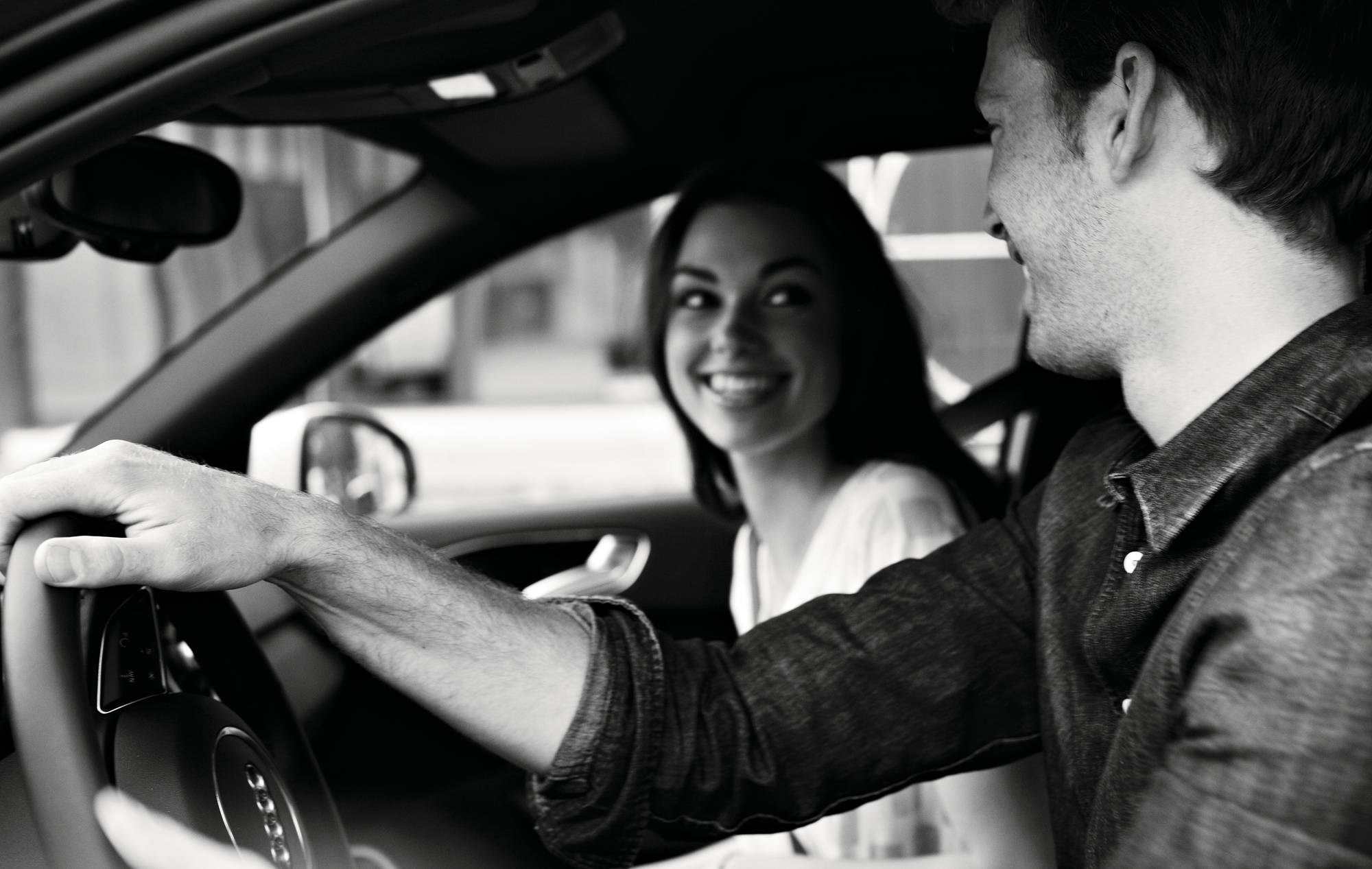 Couple driving Audi