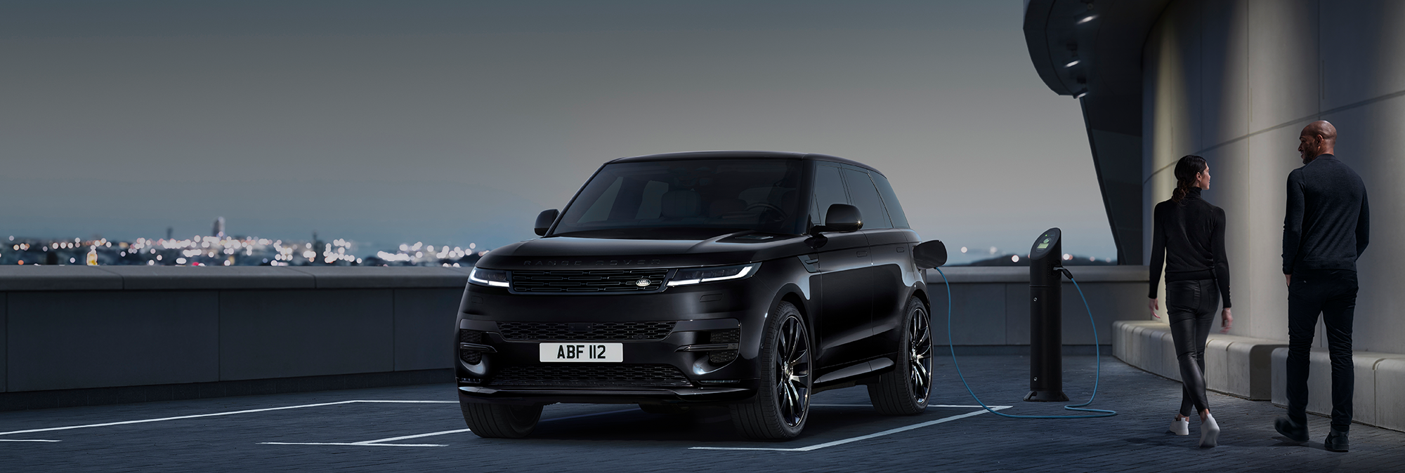 Range rover plugged into charging point