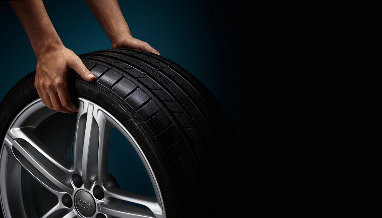 Audi tyre being held by two hands