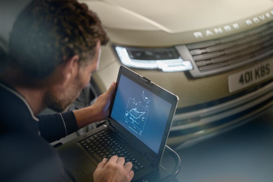 Range Rover Mechanic On laptop inspecting Range Rover model