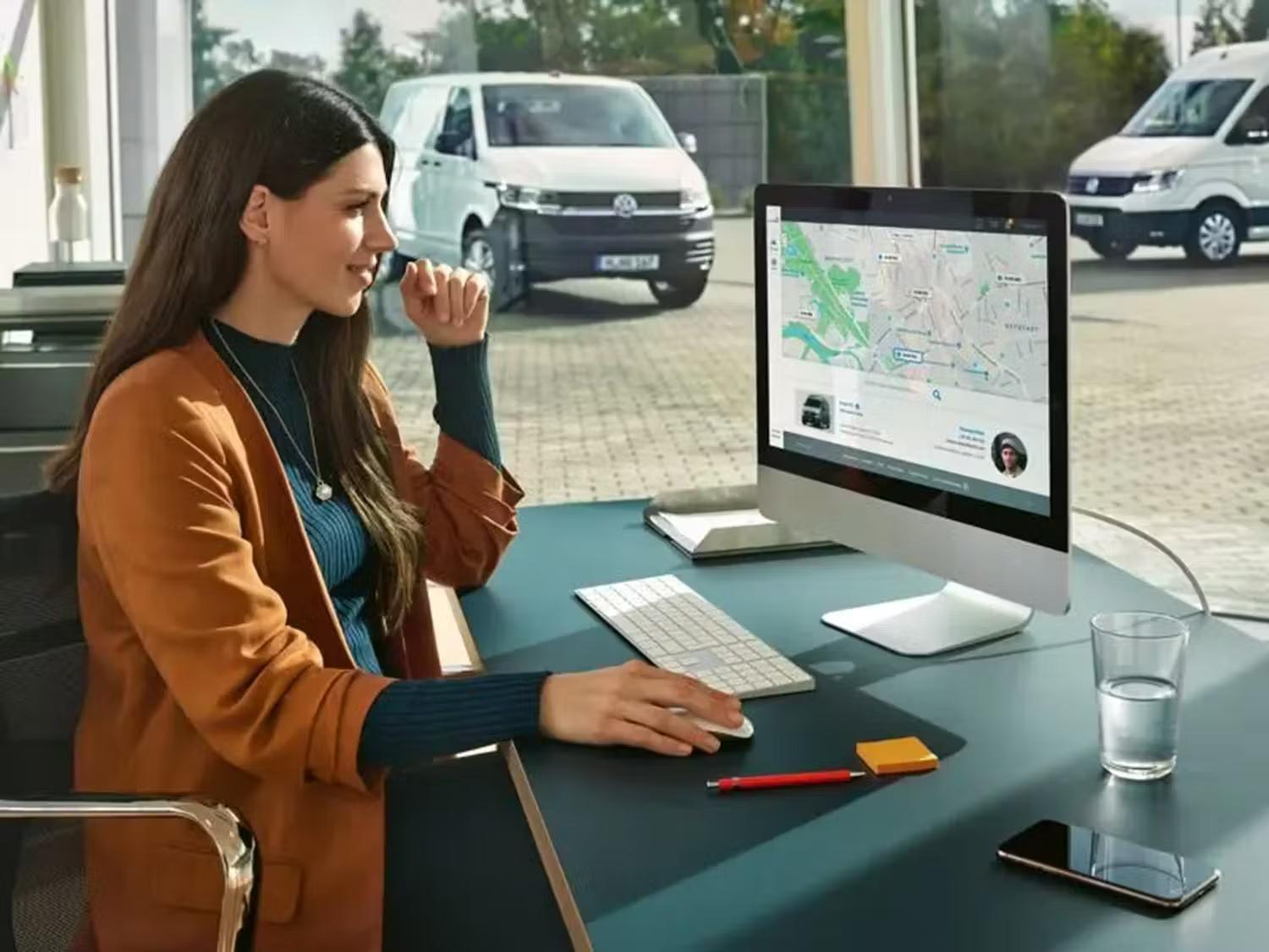 Person sat at a desk on a computer