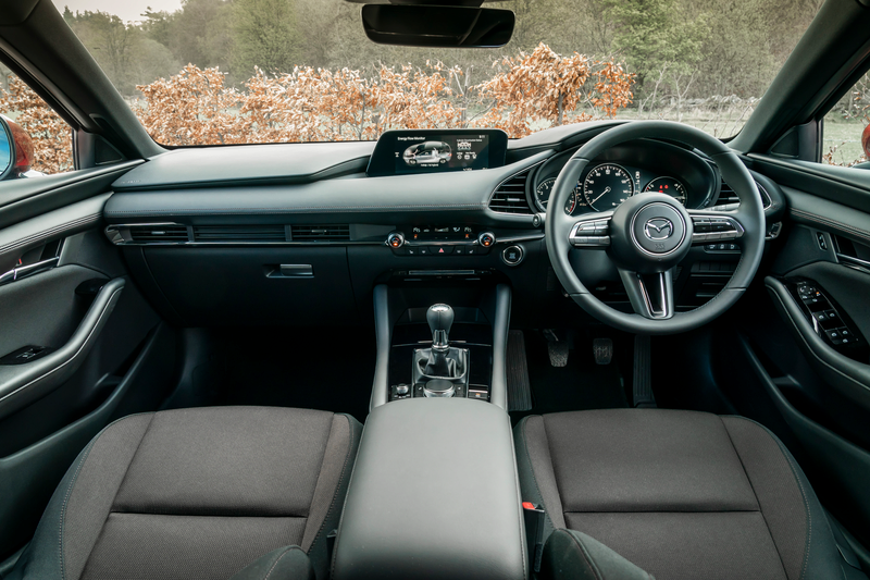 The front of the interior inside the Mazda3 hatchback, taken from the rear seats.