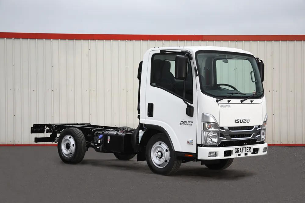 Front three-quarter view of Isuzu Grafter chassis cab truck in an industrial setting.