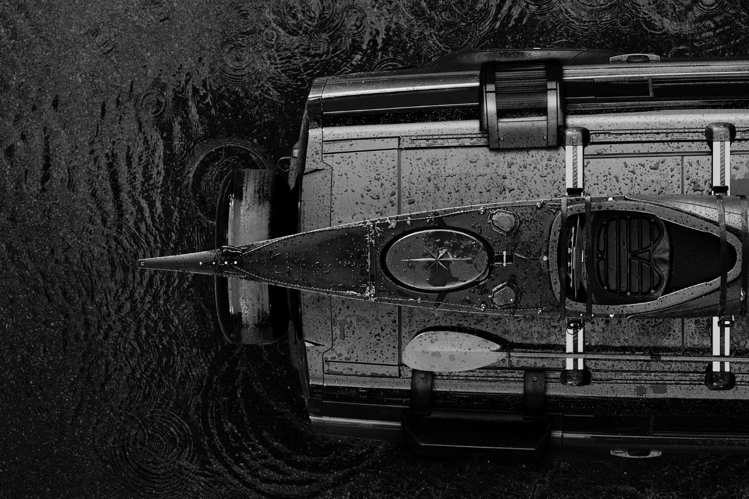 Overhead view of Land Rover Defender 110 with kayak secured to roof rack.