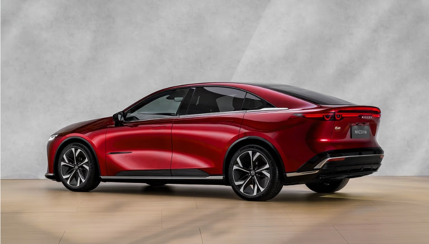 Mazda 6e in vibrant red finish showcased in a studio environment.