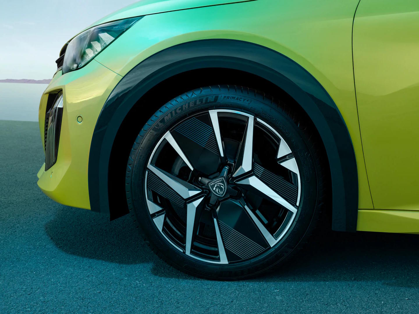 Close-up of a Peugeot alloy wheel showcasing its distinctive aerodynamic design and premium finish.