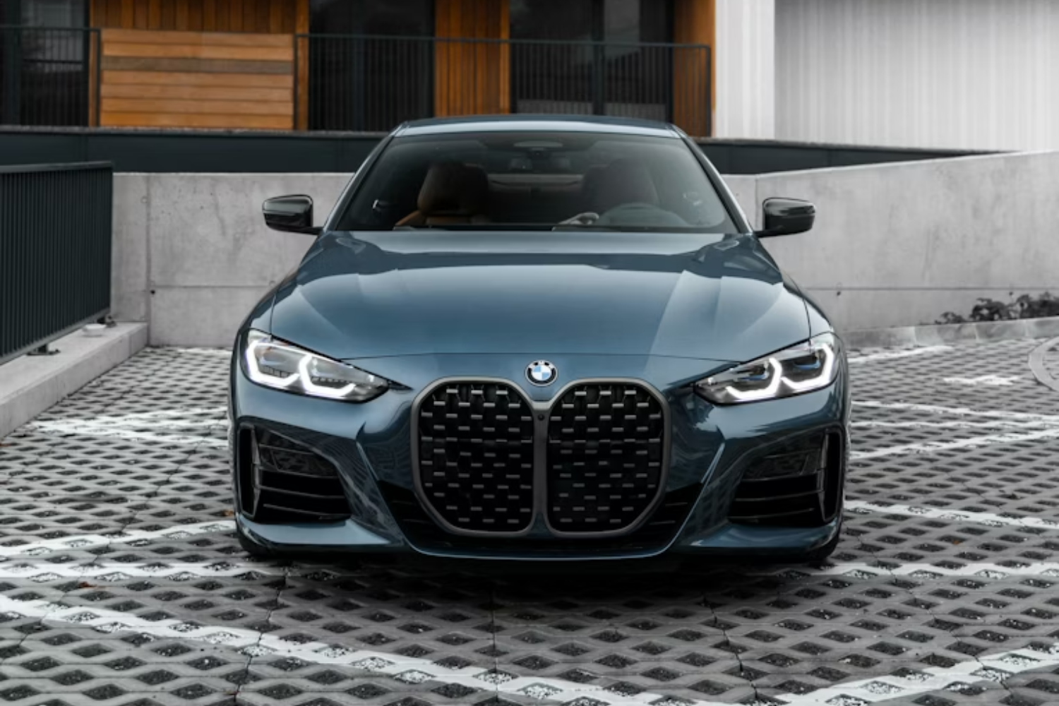BMW sedan parked outside contemporary building.