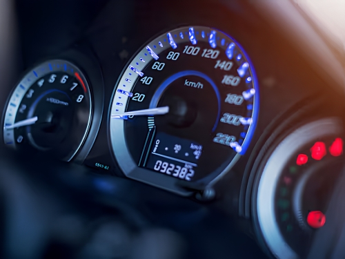Vehicle instrument cluster displaying the speedometer and dashboard information.