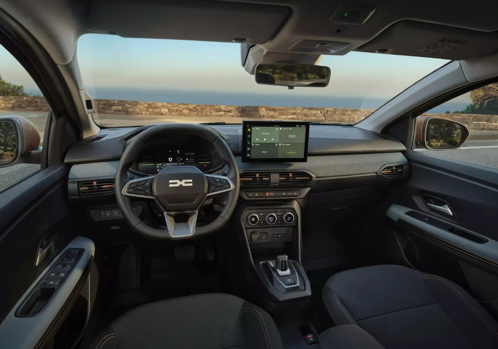 Dacia Sandero Stepway interior with steering wheel and central touchscreen display, showing infotainment system and controls.
