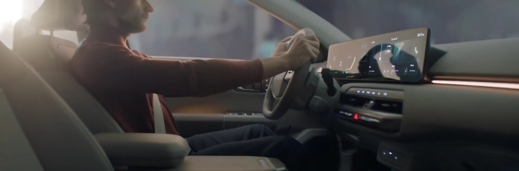 Kia EV4 interior and dashboard view with a driver seated.