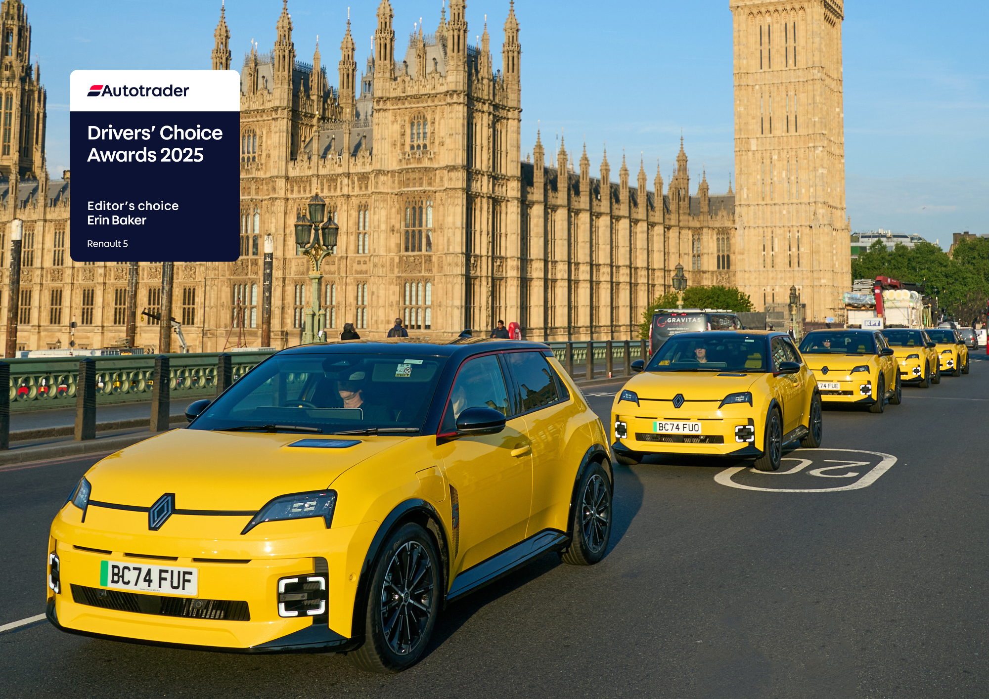 Three yellow cars driving across famous bridge in London
