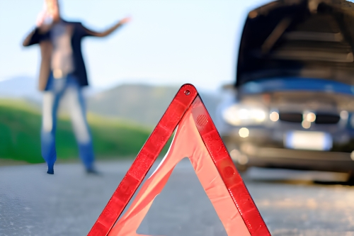 Emergency warning triangle used to alert traffic during a vehicle breakdown.
