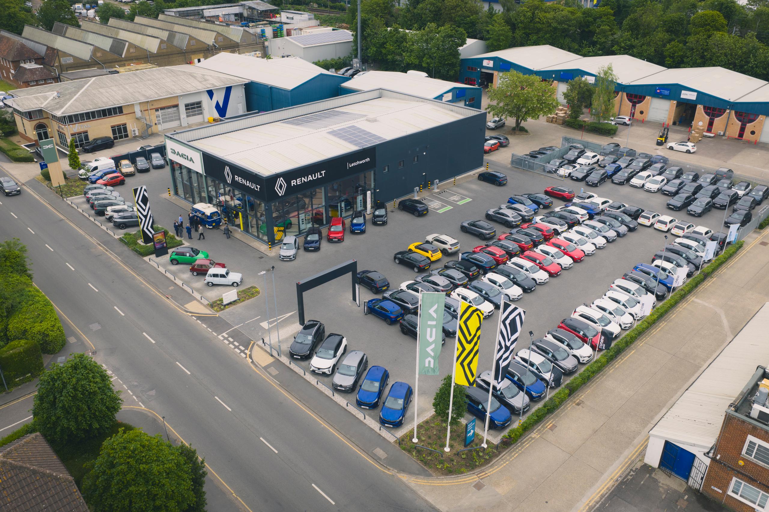 Arial view of car dealership site with colourful flags