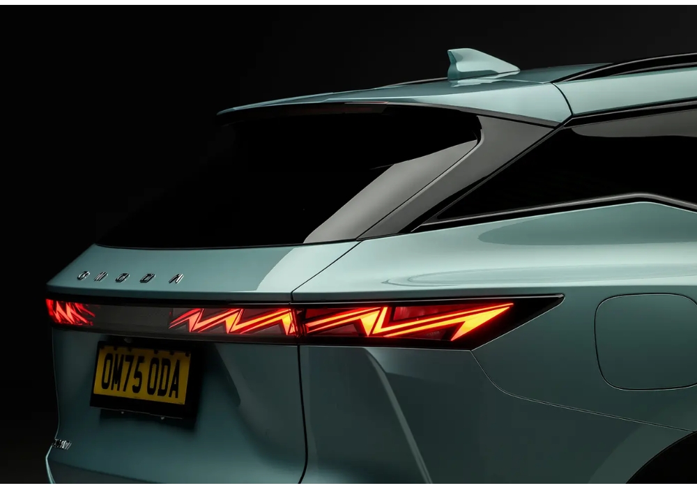 Close-up of OMODA 5 rear LED taillights with a sharp zigzag lighting signature and visible branding on the tailgate.